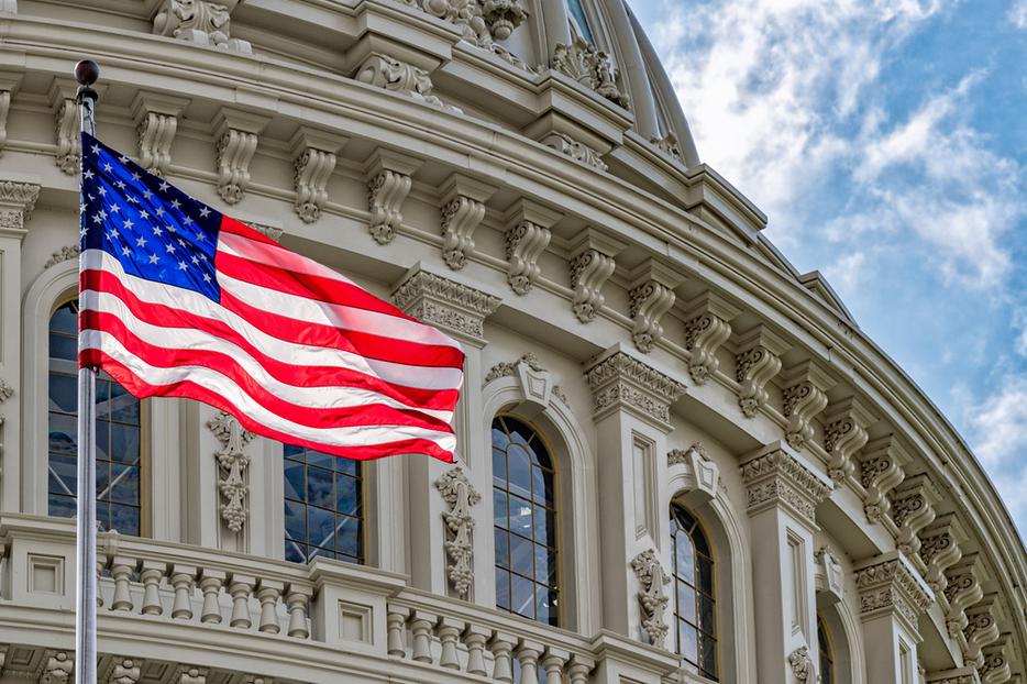 American flag flies in front of the United States Capitol building in Washington, D.C. American flag flies in front of the United States Capitol building in Washington, D.C.