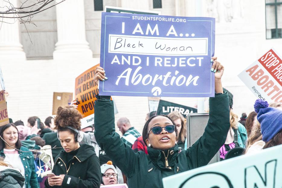 ‘I Am a Black Woman and I Reject Abortion,’ proclaims a sign held aloft by a participant at the annual March for Life. ‘I Am a Black Woman and I Reject Abortion,’ proclaims a sign held aloft by a participant at the annual March for Life.