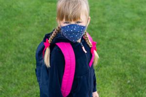 Young Catholic school girl wears a mask amid the coronavirus pandemic. Young Catholic school girl wears a mask amid the coronavirus pandemic.