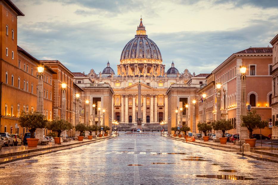 St. Peter's Basilica in the evening from Via della Conciliazione in Rome. St. Peter's Basilica in the evening from Via della Conciliazione in Rome.