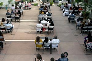Father Arturo Corral speaks during socially distanced baptism ceremonies at the historic Our Lady Queen of Angels (La Placita) Church amid the COVID-19 pandemic on Sept. 26 in Los Angeles, California. Parishioners from separate families are seated in socially distanced chairs and are required to wear face coverings to prevent the spread of the coronavirus. While the COVID-19 pandemic originally caused a backlog of around 600 baptisms at the church, La Placita is now able to conduct the ceremonies outdoors for the faithful in the church plaza. The church, dedicated in 1822 when California was a part of Mexico, primarily serves members of the Latino community and is the oldest Catholic church in Los Angeles.