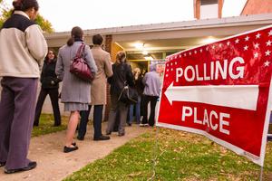 Voting polling place sign and people lined up on presidential election day. Voting polling place sign and people lined up on presidential election day.