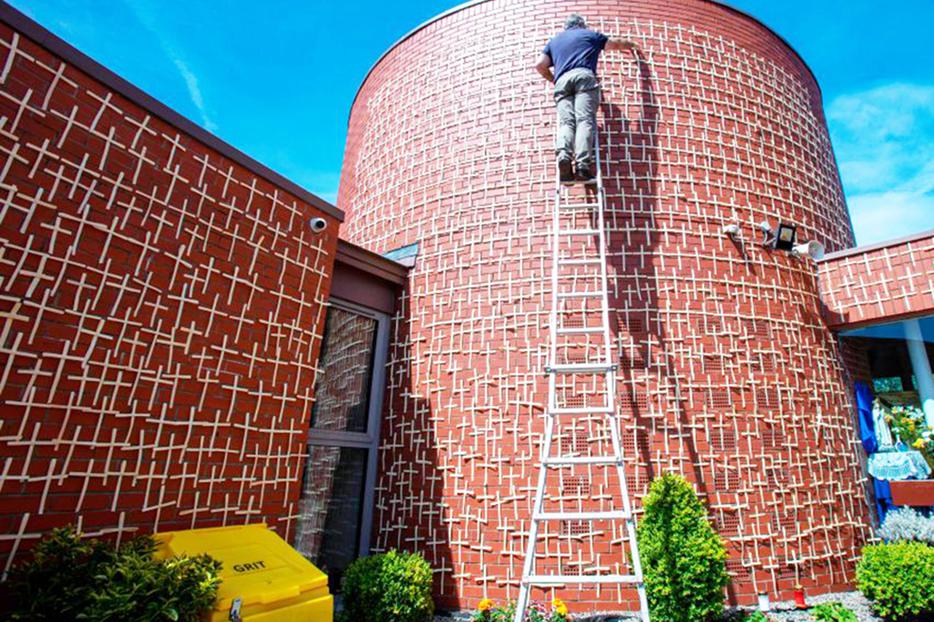 Patrick Hand adds more white palm crosses to the 2,000 that have been placed on the walls of the Church of the Ascension of the Lord in Balally, south Dublin, Ireland, on May 20, 2020. Each cross represents a victim of the COVID-19 pandemic. More than 2,000 crosses have been placed on the red brick walls in memory of those who have died in Ireland and Northern Ireland, which is equal to the approximate number of abortions in the U.S. each day. Patrick Hand adds more white palm crosses to the 2,000 that have been placed on the walls of the Church of the Ascension of the Lord in Balally, south Dublin, Ireland, on May 20, 2020. Each cross represents a victim of the COVID-19 pandemic. More than 2,000 crosses have been placed on the red brick walls in memory of those who have died in Ireland and Northern Ireland, which is equal to the approximate number of abortions in the U.S. each day.