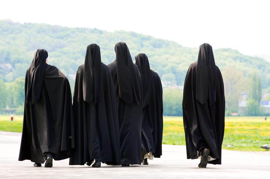 A group of nuns walking together. A group of nuns walking together.
