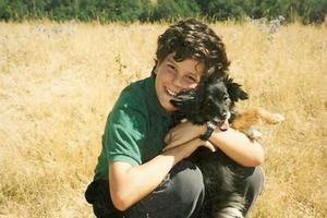 A young Carlo Acutis holds his pet dog. A young Carlo Acutis holds his pet dog.