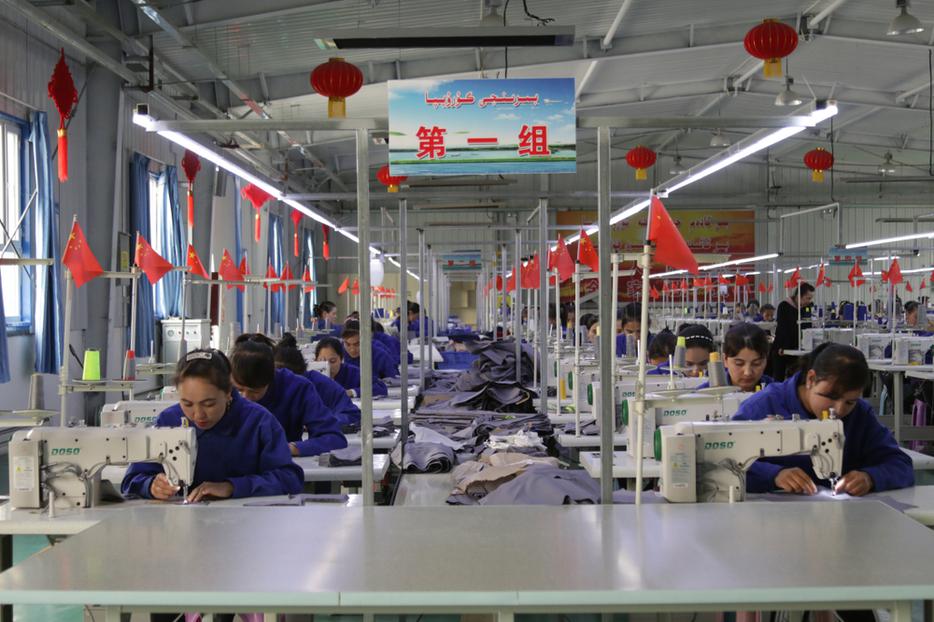 Uyghur women work in a cloth factory in Hotan county, Xinjiang province, China. Uyghur women work in a cloth factory in Hotan county, Xinjiang province, China.