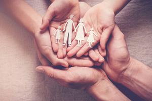 Hands come together holding a cutout forever family. Hands come together holding a cutout forever family.