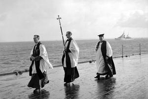 The Chaplain of the Fleet (L) and the Archbishop of Canterbury, William Temple (R) process with a crucifer for an Anglican service on the quarterdeck of HMS King George V at Scapa Flow, in the Orkney Islands, Scotland, during World War II. After the war, both institutions would undergo a steep decline in prestige and power, with the Royal Navy dropping from more than 2,000 ships to fewer than 80 operational commissioned ships in 2020, and Anglican churchgoing currently hovering around 1% of the U.K. population. The Chaplain of the Fleet (L) and the Archbishop of Canterbury, William Temple (R) process with a crucifer for an Anglican service on the quarterdeck of HMS King George V at Scapa Flow, in the Orkney Islands, Scotland, during World War II. After the war, both institutions would undergo a steep decline in prestige and power, with the Royal Navy dropping from more than 2,000 ships to fewer than 80 operational commissioned ships in 2020, and Anglican churchgoing currently hovering around 1% of the U.K. population.