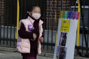A student arrives for the the first day of school at St. Bartholomew Catholic Academy in Queens, New York, Sept. 21. Catholic schools in New York City and Boston, and elsewhere, have increased enrollment as many public schools delayed in-person learning. A student arrives for the the first day of school at St. Bartholomew Catholic Academy in Queens, New York, Sept. 21. Catholic schools in New York City and Boston, and elsewhere, have increased enrollment as many public schools delayed in-person learning.
