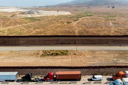 Vehicles wait to cross the Mexican border toward the United States at the Otay commercial crossing port in Tijuana, Baja California state, Mexico, on July 7. The presidential candidates differ on their approaches to border security and immigration. Vehicles wait to cross the Mexican border toward the United States at the Otay commercial crossing port in Tijuana, Baja California state, Mexico, on July 7. The presidential candidates differ on their approaches to border security and immigration.