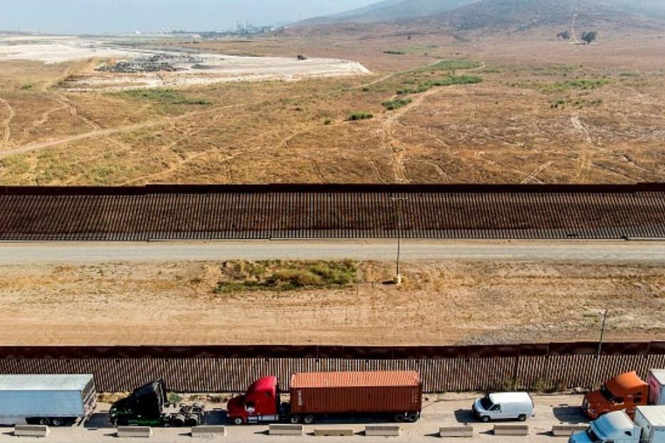 Vehicles wait to cross the Mexican border toward the United States at the Otay commercial crossing port in Tijuana, Baja California state, Mexico, on July 7. The presidential candidates differ on their approaches to border security and immigration. Vehicles wait to cross the Mexican border toward the United States at the Otay commercial crossing port in Tijuana, Baja California state, Mexico, on July 7. The presidential candidates differ on their approaches to border security and immigration.