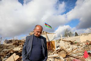 People walk by houses destroyed in a shelling attack on October 21, 2020 in Ganja, Azerbaijan. People walk by houses destroyed in a shelling attack on October 21, 2020 in Ganja, Azerbaijan.