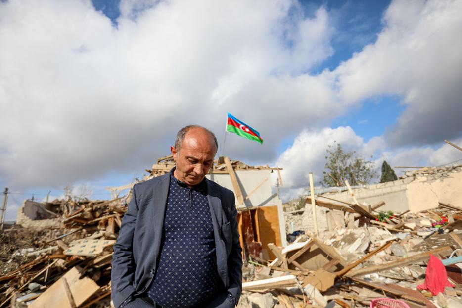 People walk by houses destroyed in a shelling attack on October 21, 2020 in Ganja, Azerbaijan. People walk by houses destroyed in a shelling attack on October 21, 2020 in Ganja, Azerbaijan.