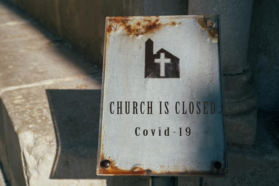 A sign outside a parish indicating the church is closed due to COVID-19. A sign outside a parish indicating the church is closed due to COVID-19.