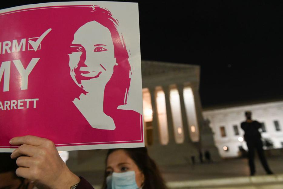 A pro-life activist and a supporter of naming Judge Amy Coney Barrett as a Supreme Court Justice, holds a sign in front of the Supreme Court building in Washington, DC on October 26, 2020. A pro-life activist and a supporter of naming Judge Amy Coney Barrett as a Supreme Court Justice, holds a sign in front of the Supreme Court building in Washington, DC on October 26, 2020.