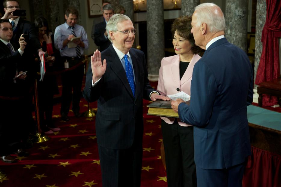 Senator Mitch McConnell with his wife Elaine Chao holding the bible is sworn in by Vice-President Joseph Biden on January 6, 2015. Senator Mitch McConnell with his wife Elaine Chao holding the bible is sworn in by Vice-President Joseph Biden on January 6, 2015.