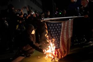 Protesters burn an American flag on November 4, 2020 in Portland, Oregon during a 'Defend Democracy' march. Protesters burn an American flag on November 4, 2020 in Portland, Oregon during a 'Defend Democracy' march.