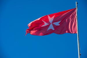 The flag of the works of the Sovereign Military Order of Malta flies over the Villa del Priorato di Malta,  located on the Aventine Hill in Rome.