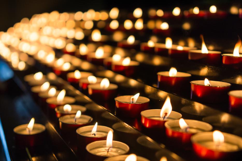 Candles burn inside a Catholic church. Candles burn inside a Catholic church.