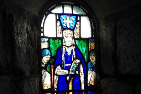 Stained glass shows a depiction of St. Margaret in her namesake chapel at the castle in Edinburgh, Scotland.