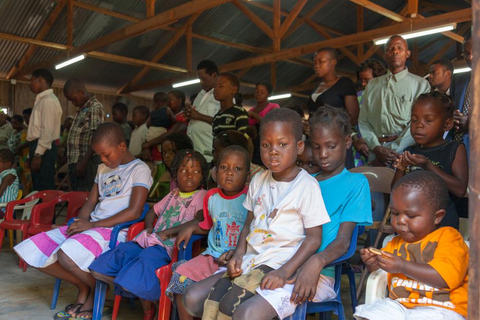 Children sit during a Sunday church service in Mozambique. Children sit during a Sunday church service in Mozambique.