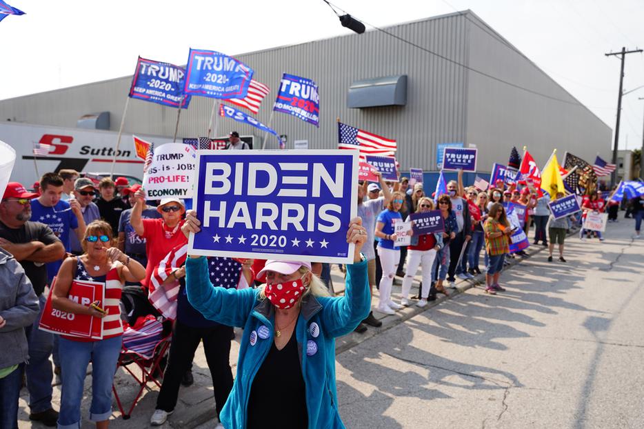 Voters hold signs during a rally outside of an aluminum foundry in Manitowoc, Wisconsin on September 21th, 2020. Voters hold signs during a rally outside of an aluminum foundry in Manitowoc, Wisconsin on September 21th, 2020.