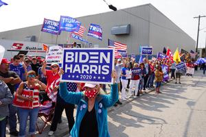 Voters hold signs during a rally outside of an aluminum foundry in Manitowoc, Wisconsin on September 21th, 2020. Voters hold signs during a rally outside of an aluminum foundry in Manitowoc, Wisconsin on September 21th, 2020.