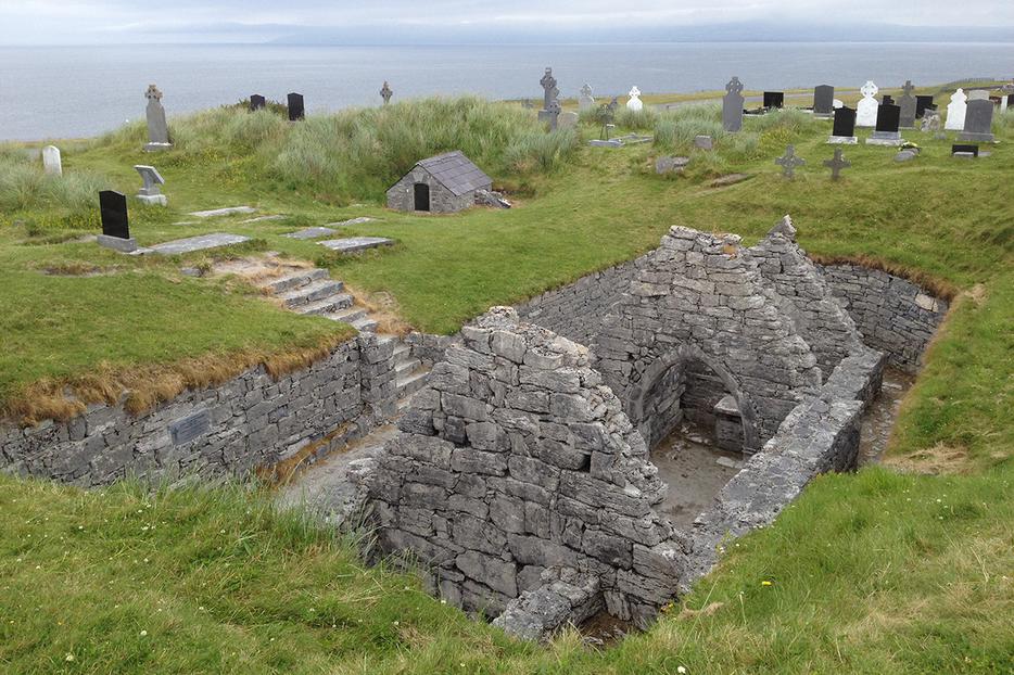 St. Caomhán’s grave behind the sunken church at Teampall Chaomháin St. Caomhán’s grave behind the sunken church at Teampall Chaomháin