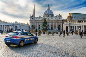 Italian police park in front of St. Peter's Basilica inside Vatican City.