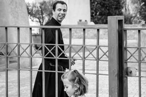 A priest smiles at a child playing just outside the first Passionist monastery in Monte Argentario, Italy. A priest smiles at a child playing just outside the first Passionist monastery in Monte Argentario, Italy.