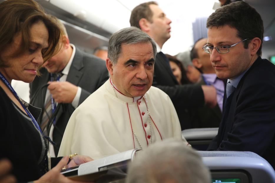 Archbishop Giovanni Angelo Becciu speaks with journalists aboard the papal flight to Colombo, Sri Lanka on Jan. 12, 2015. Archbishop Giovanni Angelo Becciu speaks with journalists aboard the papal flight to Colombo, Sri Lanka on Jan. 12, 2015.