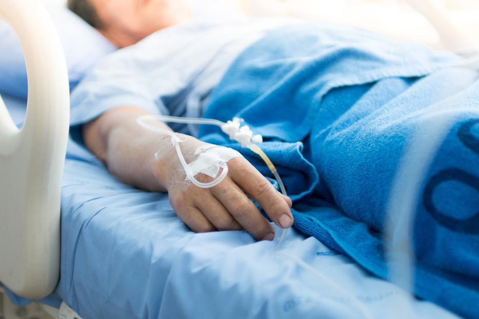 Sedated patient in hospital bed. Sedated patient in hospital bed.