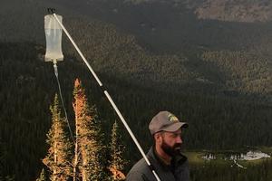 Scott Collier holds his IV on a hiking pole standing on a mountain top. His battle with cancer didn't keep him from his outdoor adventures. Scott Collier holds his IV on a hiking pole standing on a mountain top. His battle with cancer didn't keep him from his outdoor adventures.