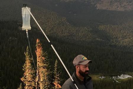 Scott Collier holds his IV on a hiking pole standing on a mountain top. His battle with cancer didn't keep him from his outdoor adventures. Scott Collier holds his IV on a hiking pole standing on a mountain top. His battle with cancer didn't keep him from his outdoor adventures.
