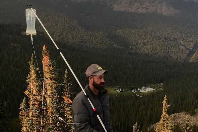 Scott Collier holds his IV on a hiking pole standing on a mountain top. His battle with cancer didn't keep him from his outdoor adventures. Scott Collier holds his IV on a hiking pole standing on a mountain top. His battle with cancer didn't keep him from his outdoor adventures.