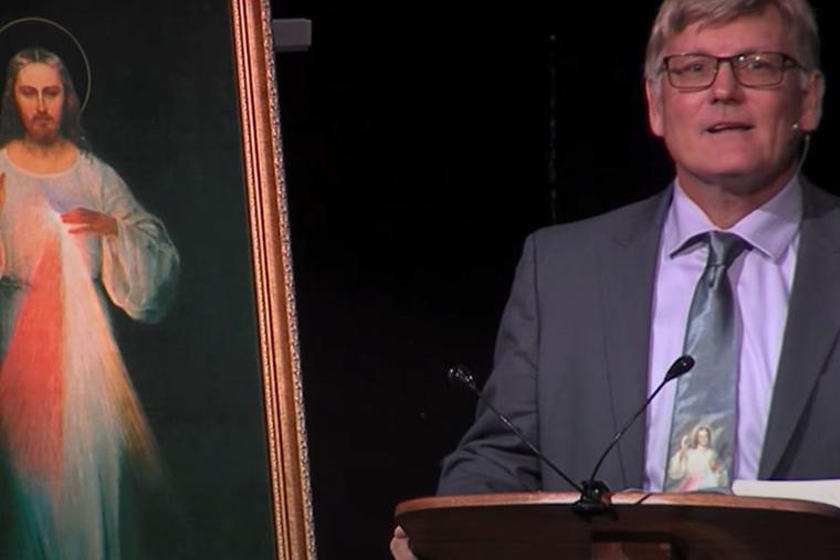 Dr. Bryan Thatcher is shown speaking about the Divine Mercy devotion. Dr. Bryan Thatcher is shown speaking about the Divine Mercy devotion.