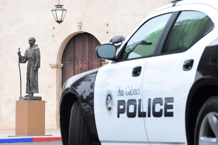 A police vehicle is seen parked near a statue of Father Junípero Serra in front of the San Gabriel Mission in San Gabriel, California, on June 21, 2020. A police vehicle is seen parked near a statue of Father Junípero Serra in front of the San Gabriel Mission in San Gabriel, California, on June 21, 2020.