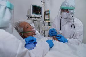 A doctor treats a COVID-19 patient amid the pandemic. A doctor treats a COVID-19 patient amid the pandemic.