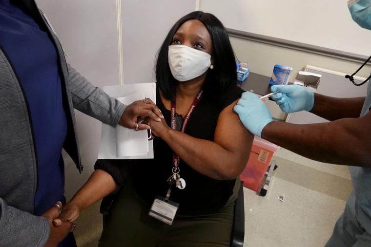 Latrice Davis, a nurse at Roseland Community Hospital, receives the COVID-19 vaccine on December 18, 2020 in Chicago, Illinois. Latrice Davis, a nurse at Roseland Community Hospital, receives the COVID-19 vaccine on December 18, 2020 in Chicago, Illinois.