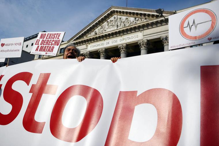 A man holds a sign reading in Spanish "There is no right to kill" during a demonstration against euthanasia called by "Derecho a Vivir" (Right to live) group in front of the Parliament in Madrid. A man holds a sign reading in Spanish "There is no right to kill" during a demonstration against euthanasia called by "Derecho a Vivir" (Right to live) group in front of the Parliament in Madrid.