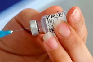A healthcare worker prepares a dose of COVID-19 vaccine at Maccabi Health Services in the Israeli coastal city of Herzliya, north of Tel Aviv, on December 21, 2020. Israel has ordered 14 million doses of the vaccine -- covering seven million people, as two doses are required per person for optimal protection -- from Pfizer as well as US biotech firm Moderna. A healthcare worker prepares a dose of COVID-19 vaccine at Maccabi Health Services in the Israeli coastal city of Herzliya, north of Tel Aviv, on December 21, 2020. Israel has ordered 14 million doses of the vaccine -- covering seven million people, as two doses are required per person for optimal protection -- from Pfizer as well as US biotech firm Moderna.
