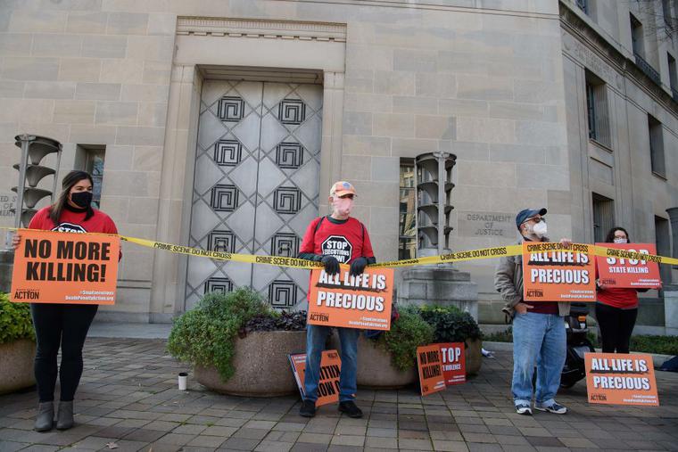 Demonstrators protest federal executions of death row inmates, in front of the US Justice Department in Washington, DC, on December 10, 2020. Demonstrators protest federal executions of death row inmates, in front of the US Justice Department in Washington, DC, on December 10, 2020.