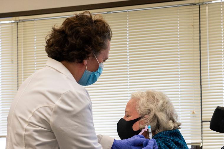 Pharmacist Serena Burgdorf administers a Covid-19 Moderna vaccine shot to Christine Griffin, Army Veteran, who has a spinal injury and is inpatient at the West Roxbury VA Medical Center in Boston, MA on December 23, 2020. The VA is vaccinating front line workers and at risk patients during phase one. Pharmacist Serena Burgdorf administers a Covid-19 Moderna vaccine shot to Christine Griffin, Army Veteran, who has a spinal injury and is inpatient at the West Roxbury VA Medical Center in Boston, MA on December 23, 2020. The VA is vaccinating front line workers and at risk patients during phase one.