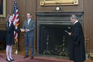 Chief Justice John G. Roberts, Jr., administers the judicial oath to Judge Amy Coney Barrett in the East Conference Room of the Supreme Court Building. Judge Barrett's husband, Jesse M. Barrett, holds the Bible. Chief Justice John G. Roberts, Jr., administers the judicial oath to Judge Amy Coney Barrett in the East Conference Room of the Supreme Court Building. Judge Barrett's husband, Jesse M. Barrett, holds the Bible.