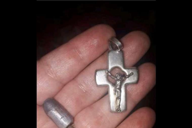 A bullet next to the crucifix that saved a young boy's life. A bullet next to the crucifix that saved a young boy's life.