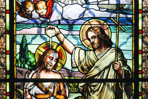 Jesus Christ is shown being baptized by St. John the Baptist in an old stained-glass window. Jesus Christ is shown being baptized by St. John the Baptist in an old stained-glass window.