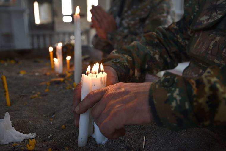 Armenian soldiers pray on Nov. 1 in the damaged Ghazanchetsots Cathedral in the historic city of Shusha. Armenian soldiers pray on Nov. 1 in the damaged Ghazanchetsots Cathedral in the historic city of Shusha.