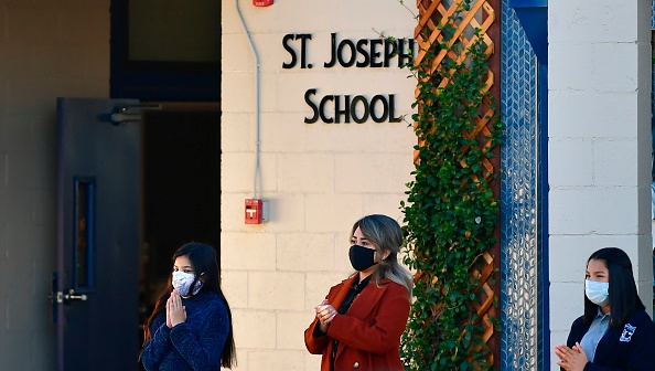 Students attend morning prayers in the courtyard at St. Joseph Catholic School in La Puente, California, on Nov. 16, 2020, where pre-kindergarten to second-grade students in need of special services returned to the classroom for in-person instruction. The campus was the second Catholic school in Los Angeles County to receive a waiver approval to reopen as the coronavirus pandemic raged on. Students attend morning prayers in the courtyard at St. Joseph Catholic School in La Puente, California, on Nov. 16, 2020, where pre-kindergarten to second-grade students in need of special services returned to the classroom for in-person instruction. The campus was the second Catholic school in Los Angeles County to receive a waiver approval to reopen as the coronavirus pandemic raged on.