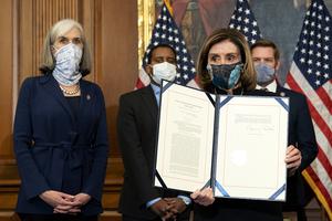 Speaker of the House Nancy Pelosi (D-CA) displays a signed article of impeachment against President Donald Trump at the U.S. Capitol on Wednesday in Washington, DC. The House of Representatives voted to impeach Trump a second time, after Vice President Mike Pence declined to use the 25th amendment to remove him from office after protestors breached the U.S. Capitol last week. Speaker of the House Nancy Pelosi (D-CA) displays a signed article of impeachment against President Donald Trump at the U.S. Capitol on Wednesday in Washington, DC. The House of Representatives voted to impeach Trump a second time, after Vice President Mike Pence declined to use the 25th amendment to remove him from office after protestors breached the U.S. Capitol last week.