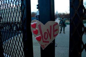 A sign reading "Love" is placed on a barrier outside the US Capitol as National Guard troops stand guard ahead of the inauguration ceremonies for President-elect Joe Biden and Vice President-elect Kamala Harris on January 18, 2021 in Washington, DC. A sign reading "Love" is placed on a barrier outside the US Capitol as National Guard troops stand guard ahead of the inauguration ceremonies for President-elect Joe Biden and Vice President-elect Kamala Harris on January 18, 2021 in Washington, DC.